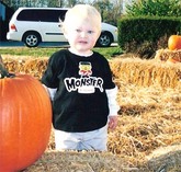 Little boy in a pumpkin patch.