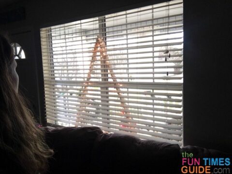 This DIY Christmas tree frame is slim enough to fit behind the window blinds too -- even wrapped in lights!