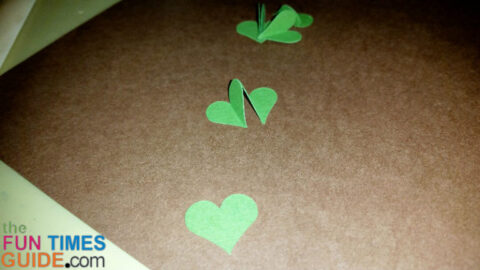 Making clover leaves from punched hearts. photo by Suzie at TheFunTimesGuide.com make-shamrock-hearts